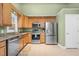 Cozy kitchen with stainless steel appliances, granite countertops, and light cabinetry at 107 Fishers Creek Ct, Cary, NC 27513