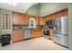 This is a bright kitchen featuring stainless steel appliances, light wood cabinets, and tile floors at 107 Fishers Creek Ct, Cary, NC 27513