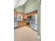 Updated kitchen features stainless steel appliances, granite counters, and tiled floors at 107 Fishers Creek Ct, Cary, NC 27513