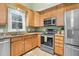 Close-up shot of the stainless steel appliances and granite countertops in the kitchen at 107 Fishers Creek Ct, Cary, NC 27513