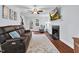 Cozy living room with fireplace, hardwood floors, ceiling fan, and ample natural light at 107 Fishers Creek Ct, Cary, NC 27513