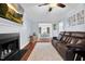 Open living room with fireplace, hardwood floors, and seamless access to the dining area at 107 Fishers Creek Ct, Cary, NC 27513