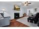 Open living room with fireplace, hardwood floors, and seamless access to the dining area at 107 Fishers Creek Ct, Cary, NC 27513