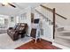 Inviting living room featuring staircase access and a comfortable seating area at 107 Fishers Creek Ct, Cary, NC 27513