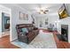 Bright living room with hardwood floors, stairs, ceiling fan, and plenty of natural light at 107 Fishers Creek Ct, Cary, NC 27513