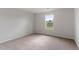 Carpeted bedroom featuring a large window letting in lots of natural light and backyard views at 107 Scoville St, Oxford, NC 27565