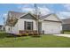 Inviting single-Gathering home with an attached garage, manicured lawn and stone accents at 108 Hybrid St, Oxford, NC 27565