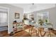 Bright dining area featuring a round table, a stainless steel dishwasher, and hardwood floors at 11 Marsh Landing Ct, Durham, NC 27703