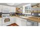 Well-lit kitchen with white cabinets, stainless steel appliances, and functional open shelving at 11 Marsh Landing Ct, Durham, NC 27703