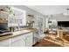 Modern kitchen with stainless steel dishwasher flowing into a sun-drenched dining and living area at 11 Marsh Landing Ct, Durham, NC 27703