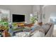 Living room featuring a comfortable sectional sofa, entertainment center, and plenty of natural light at 11 Marsh Landing Ct, Durham, NC 27703