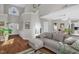 Spacious living room with a comfortable gray sectional sofa, hardwood floors, and abundant natural light at 11 Marsh Landing Ct, Durham, NC 27703