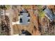 Aerial view of a house surrounded by lush greenery, showcasing its roof and driveway at 112 Rawhide Dr, Louisburg, NC 27549