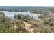 Picturesque aerial view of lakefront homes nestled among lush trees, offering serene waterfront living at 112 Rawhide Dr, Louisburg, NC 27549