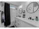 Elegant bathroom showcasing double vanity, modern fixtures, and a sleek, tiled shower at 112 Rawhide Dr, Louisburg, NC 27549