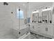 Modern bathroom showcasing a glass enclosed shower, soaking tub, and dual vanity sinks at 112 Rawhide Dr, Louisburg, NC 27549