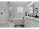 A luxurious bathroom boasts a soaking tub, glass shower, double vanity, and modern fixtures at 112 Rawhide Dr, Louisburg, NC 27549