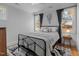 Comfortable bedroom with a metal bed frame, neutral walls, and large windows offering ample natural light at 112 Rawhide Dr, Louisburg, NC 27549