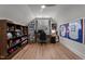 Bonus room features a baseball memorabilia, a ceiling fan, a window, a wooden bookcase and a desk at 112 Rawhide Dr, Louisburg, NC 27549