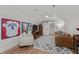 The bonus room features a comfortable leather couch, light gray armchair, baseball memorabilia, and a ceiling fan at 112 Rawhide Dr, Louisburg, NC 27549