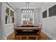 Bright dining room with a modern chandelier and a view of the backyard at 112 Rawhide Dr, Louisburg, NC 27549