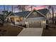 Charming home with a covered porch, attached garage, and meticulously maintained landscaping at 112 Rawhide Dr, Louisburg, NC 27549