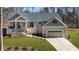 Charming home with a well-manicured lawn, front porch, and attached two car garage at 112 Rawhide Dr, Louisburg, NC 27549