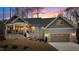 Charming home with a brick foundation, two-car garage, and beautiful landscaping at sunset at 112 Rawhide Dr, Louisburg, NC 27549