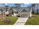 Beautiful home with a well-manicured lawn, welcoming front porch, and convenient two-car garage at 112 Rawhide Dr, Louisburg, NC 27549