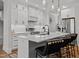 Modern kitchen with white cabinets, stainless steel appliances, and a large center island with seating at 112 Rawhide Dr, Louisburg, NC 27549