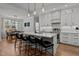 Stylish kitchen with white cabinets, a large island, and a dining area at 112 Rawhide Dr, Louisburg, NC 27549