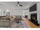 Spacious living room with a fireplace, ceiling fan, and hardwood floors at 112 Rawhide Dr, Louisburg, NC 27549