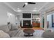 Inviting living room with a fireplace, large TV, and access to the porch at 112 Rawhide Dr, Louisburg, NC 27549