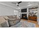 Comfortable living room with a fireplace, ceiling fan, and hardwood floors at 112 Rawhide Dr, Louisburg, NC 27549