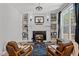 Cozy living room with a fireplace, built-in bookshelves, and natural light at 112 Rawhide Dr, Louisburg, NC 27549