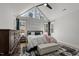 Bright main bedroom features a vaulted ceiling, large windows, dark wood furnishings, and a stylish rug at 112 Rawhide Dr, Louisburg, NC 27549