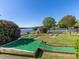 Enjoy a round of miniature golf by the lake with beautiful flowers and landscaping at 112 Rawhide Dr, Louisburg, NC 27549