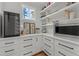 Organized pantry with custom shelving, wine cooler, and ample storage for appliances at 112 Rawhide Dr, Louisburg, NC 27549