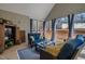 Inviting screened porch with cozy seating, blue curtains, and scenic backyard views at 112 Rawhide Dr, Louisburg, NC 27549