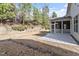 A stone patio sits adjacent to a screened in porch in this backyard at 1135 Rosepine Dr, Cary, NC 27519