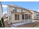 The home features a rear screened in porch and stone patio at 1135 Rosepine Dr, Cary, NC 27519