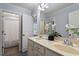 Bathroom featuring double sinks, a large mirror, and a separate shower area at 1135 Rosepine Dr, Cary, NC 27519