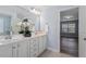 Bright bathroom featuring a double vanity, large mirror, and neutral toned walls at 1135 Rosepine Dr, Cary, NC 27519