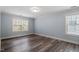 Bedroom with neutral walls and hardwood flooring illuminated by natural light at 1135 Rosepine Dr, Cary, NC 27519