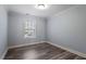 Bright bedroom featuring hardwood floors, neutral walls, and natural light at 1135 Rosepine Dr, Cary, NC 27519
