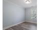 Bright bedroom featuring hardwood floors, neutral walls, and natural light at 1135 Rosepine Dr, Cary, NC 27519