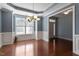 Dining room with hardwood floors, wainscoting, and abundant natural light at 1135 Rosepine Dr, Cary, NC 27519