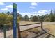 Welcoming entrance to Nancy Branch with a brick path, wooden fence and scenic views of the community at 1135 Rosepine Dr, Cary, NC 27519