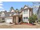 Attractive two-story home with stone accents, a two-car garage, and manicured landscaping at 1135 Rosepine Dr, Cary, NC 27519
