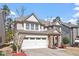 Beautiful two-story home featuring stone details, a two-car garage, and lovely landscaping at 1135 Rosepine Dr, Cary, NC 27519
